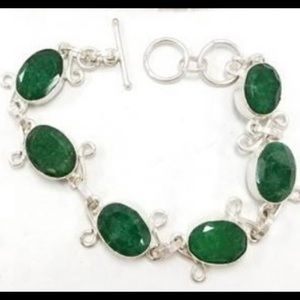 Silver tone oval emerald link bracelet with a toggle closure